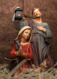 A detailed sculpture depicting the Holy Family in a nativity scene with serene expressions and lifelike details.